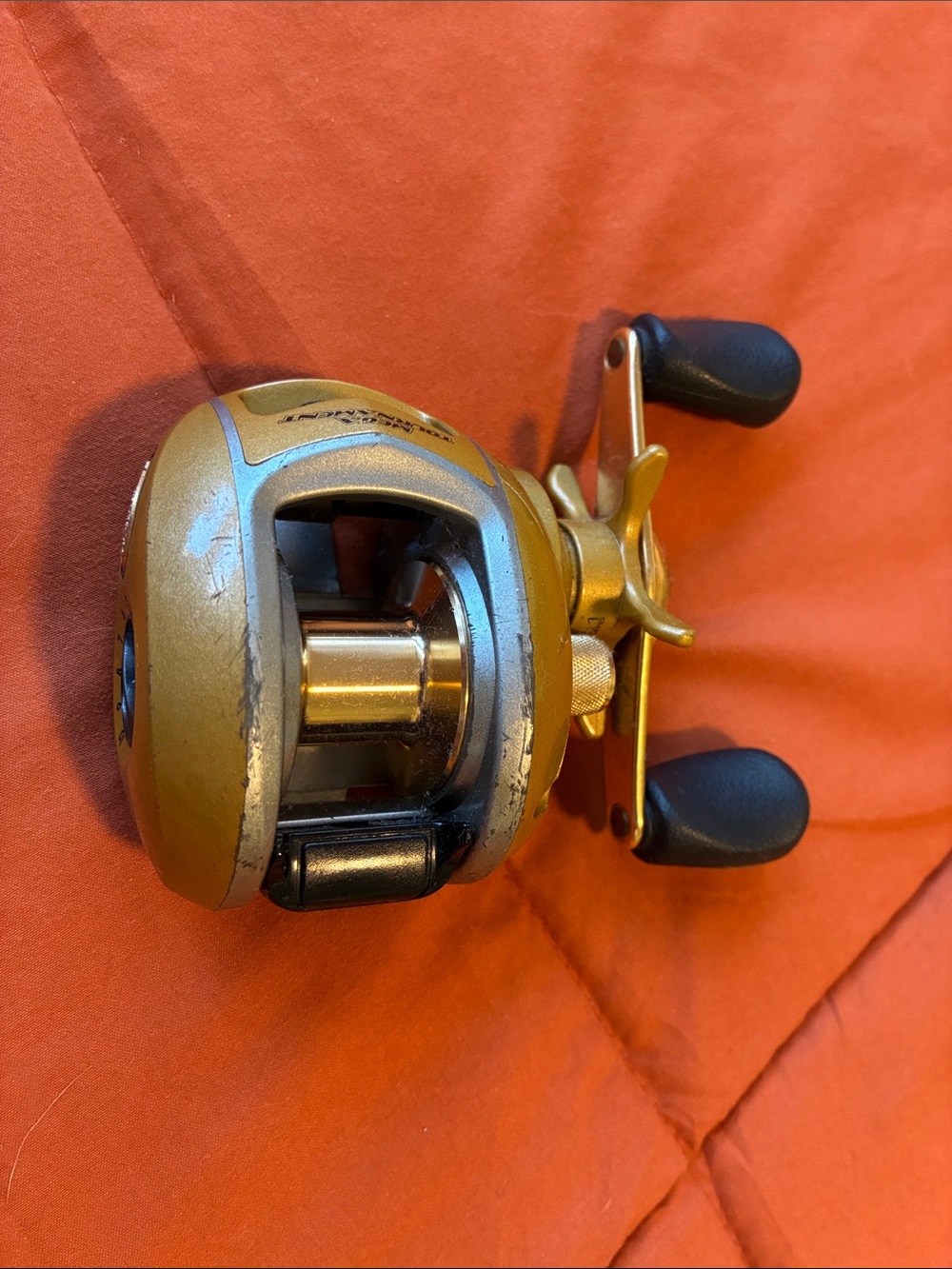Bass Pro Shops Gold and Black Baitcasting Reel